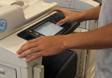 hands selecting items on printer screen