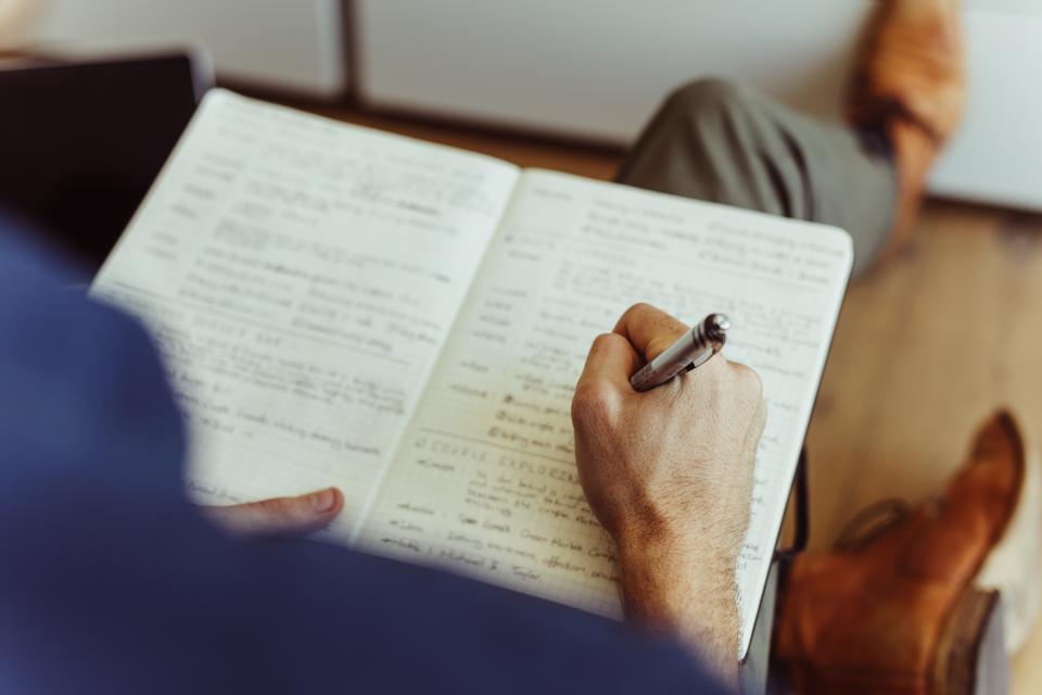 decorative image of a student taking notes